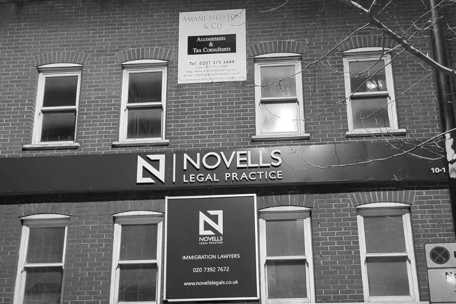 Black-and-white exterior photograph showing Novells Legal Practice signage and its N monogram