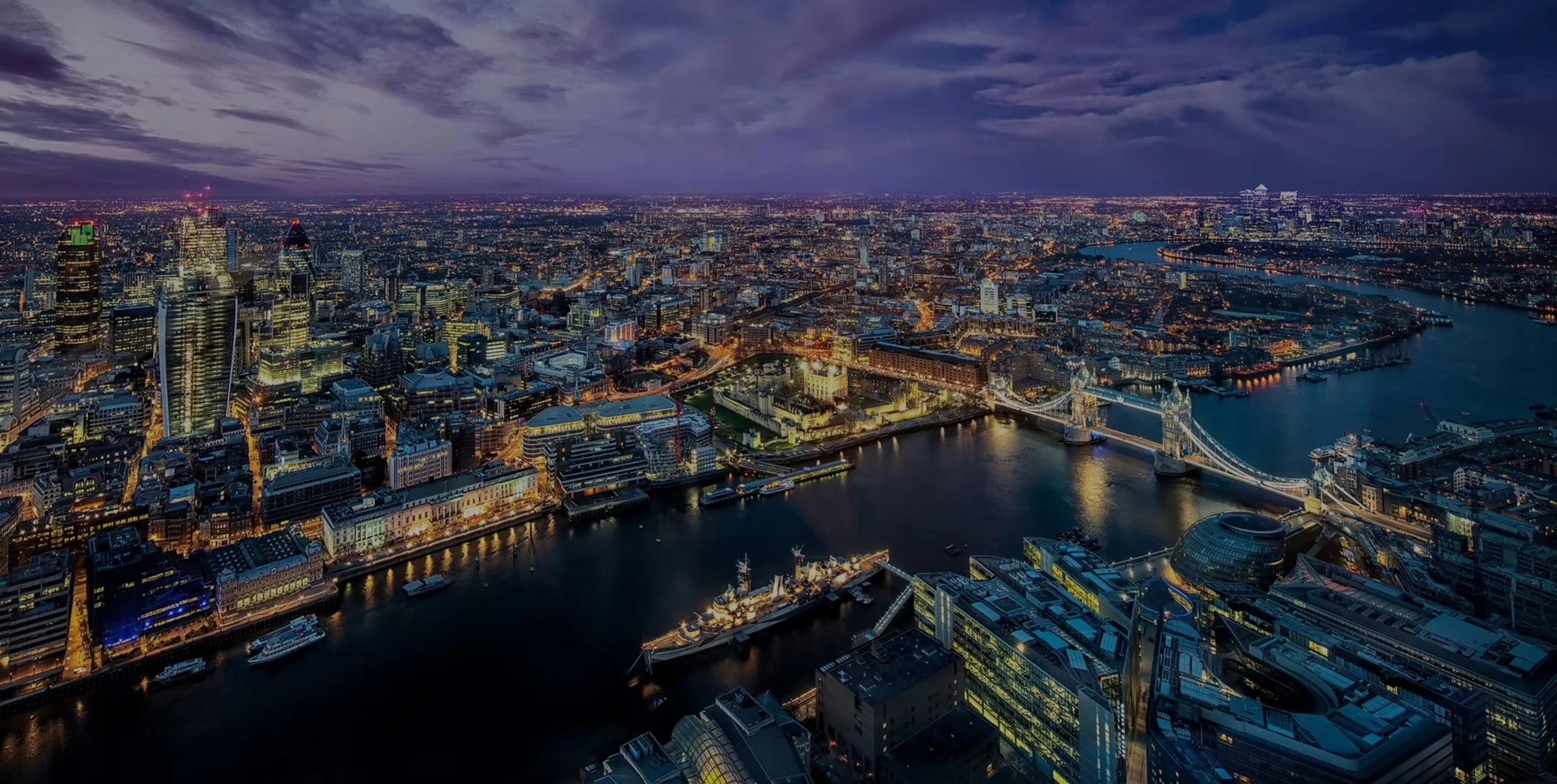 Aerial view of London, the River Thames and Tower Bridge at dusk